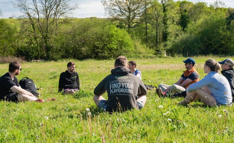 Group of people sat in field